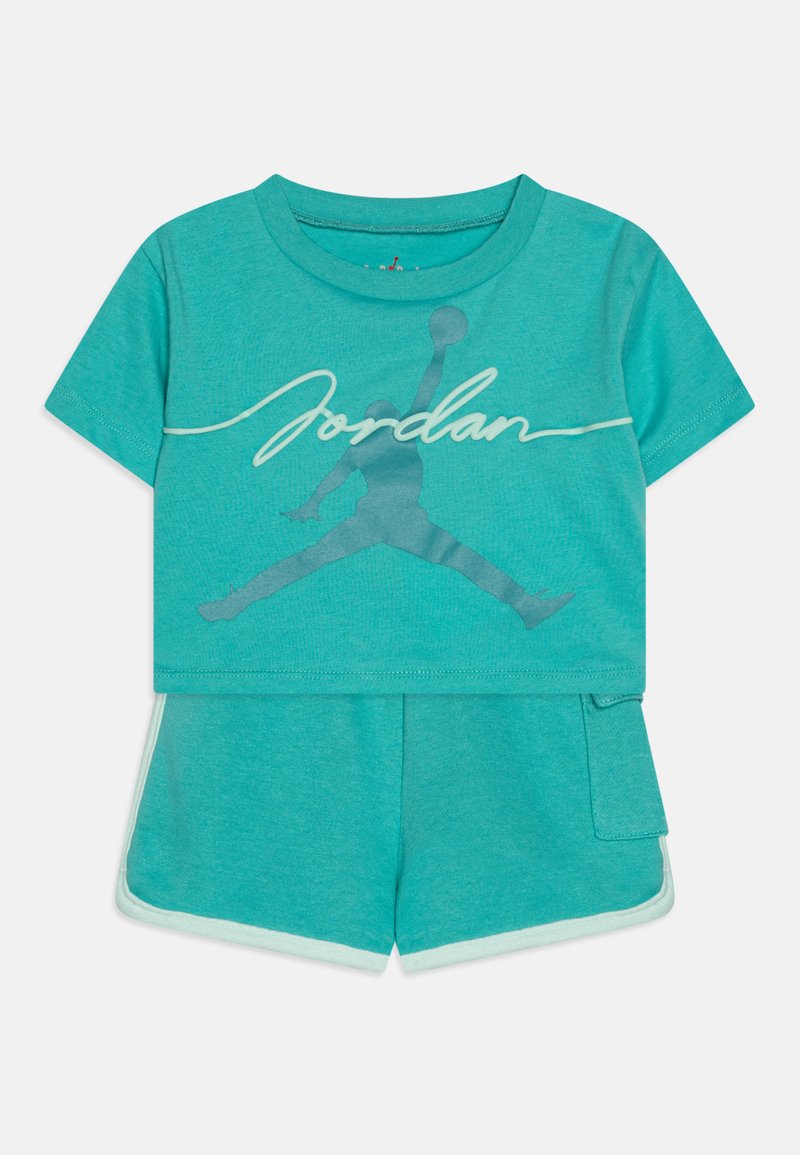 Teal children’s two-piece outfit featuring a short-sleeve shirt with “Jordan” text and logo, paired with matching shorts and a side pocket.
