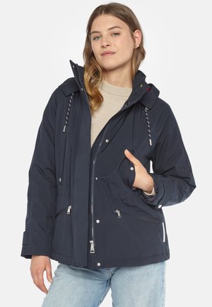 Navy waterproof jacket with a hood, front zip closure, adjustable drawstrings, side pockets, and elastic cuffs, made from durable fabric.
