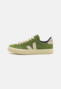 Green suede sneaker with cream laces and accents, featuring a distinctive V logo on the side and a low-profile rubber sole.