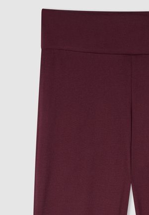 Leggings bordeaux a vita alta, texture liscia, tessuto elastico, cuciture minimali, design aderente. Adatti per l'abbigliamento sportivo o per un uso casual.