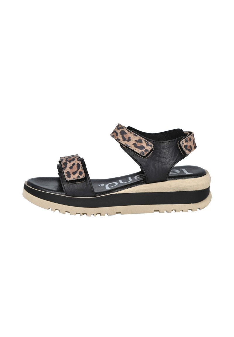 Sándalo negro con correas de estampado de leopardo, cierres ajustables de gancho y bucle, suela acolchada y una plataforma gruesa de color beige para mayor altura.