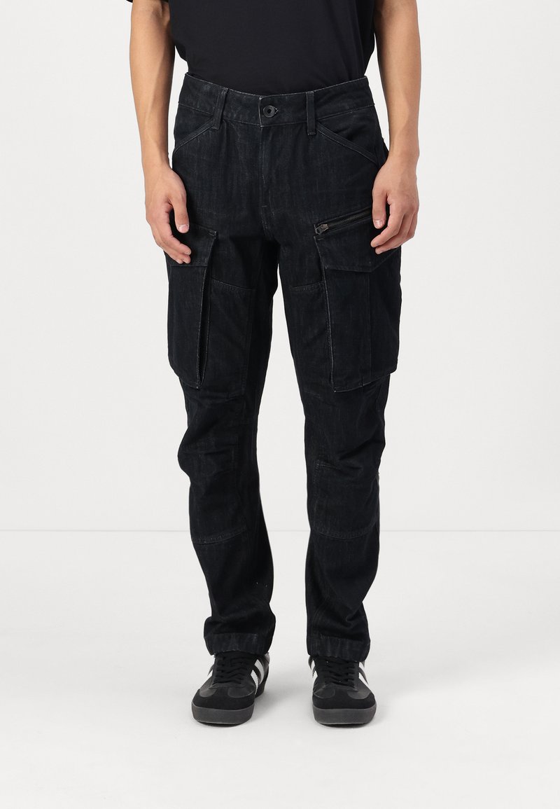 Black cargo pants with a textured fabric, featuring multiple pockets, a zippered pocket, and a straight-leg design.