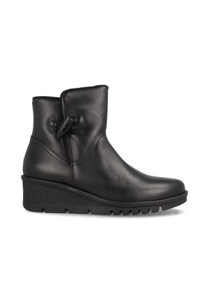 Botas de tobillo de cuero negro con punta redonda, tacón en cuña y detalle decorativo de correa lateral. Superficie lisa con suela texturizada.