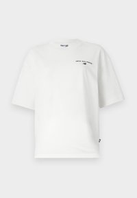 White cotton t-shirt with short sleeves, crew neck, and black "New Balance" logo on the chest. Loose fit and smooth texture.
