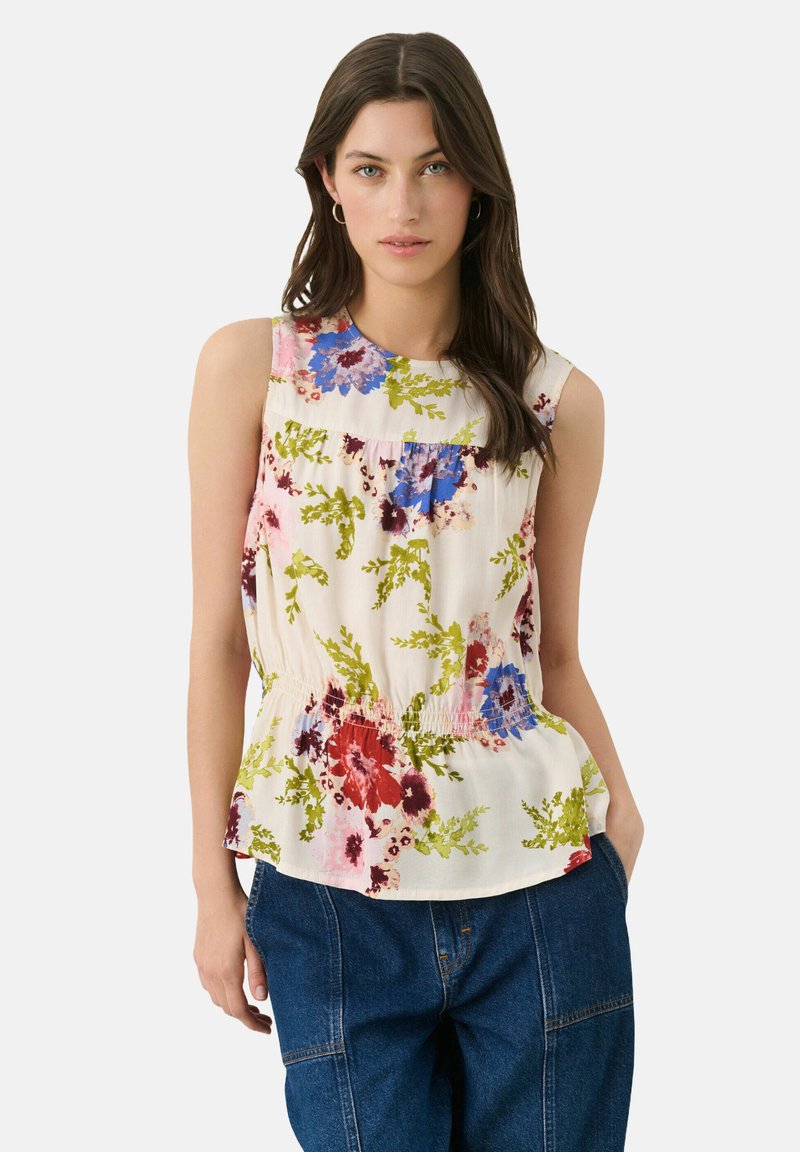 Floral sleeveless top in cream, featuring blue, pink, and green botanical prints. Gathered waist design with lightweight fabric.