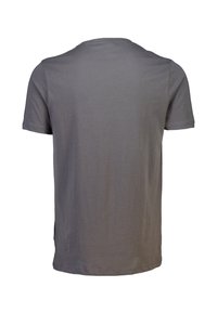 Camiseta corta gris sin mangas mostrada desde la parte de atrás con cuello redondo y sin logotipos ni diseños visibles.
