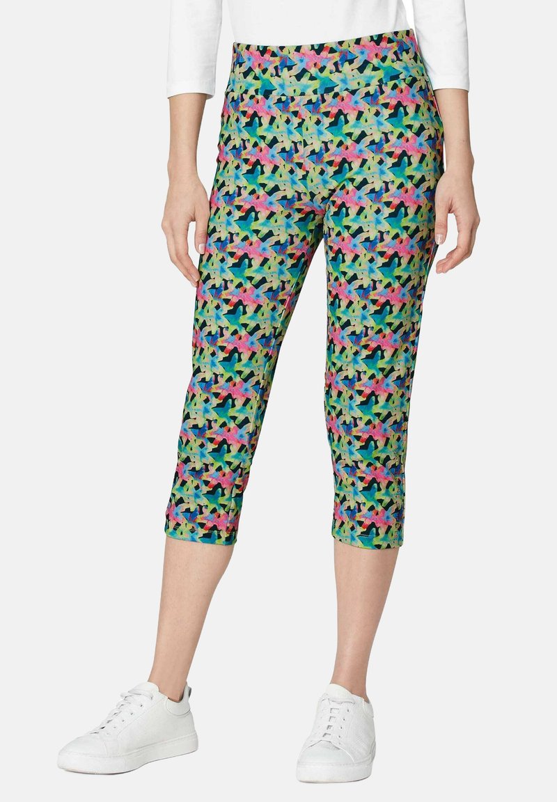 Capri leggings in een kleurrijk abstract patroon met groene, roze, blauwe en paarse tinten. Gemaakt van een rekbare, lichte stof.
