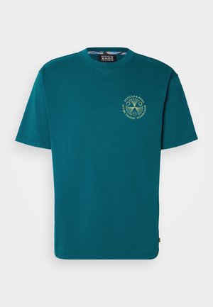 Turquoise cotton t-shirt with a crew neckline, short sleeves, and a circular logo in yellow-green on the chest. Smooth texture.