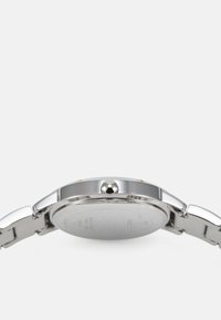 Silver wristwatch with a polished metal case, crown at 3 o'clock, and a smooth stainless steel bracelet. Minimalist design, no visible markings.