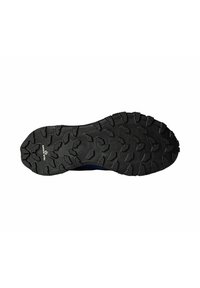 Suela de zapato de goma negra con patrones de tracción multidireccionales y surcos para mayor agarre, destacando un logotipo prominente cerca del talón.