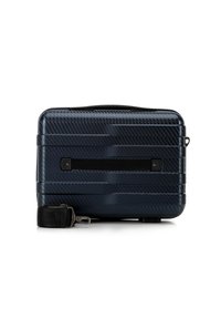 Valigia rigida di colore blu scuro, con finitura testurizzata e scanalature orizzontali, dotata di una tracolla nera rimovibile e chiusure in metallo.