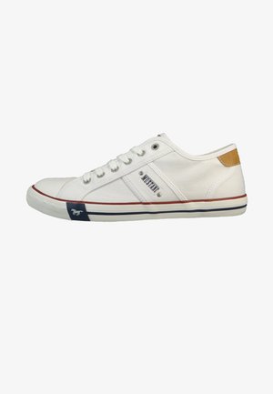 White canvas sneaker with a rounded toe, lace-up front, and navy accents. Features a brown leather heel tab and a rubber sole.
