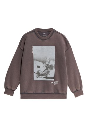 Brauner übergroßer Sweatshirt aus Baumwolle, mit einem grafischen Druck eines Skateboardfahrers in Schwarz und Weiß. Gerippte Bündchen und Halsausschnitt.