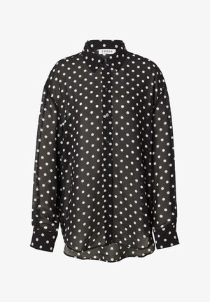 Schwarze transparente Bluse mit weißen, runden Punkten, klassischem Kragen und langen Ärmel mit geknöpften Manschetten.