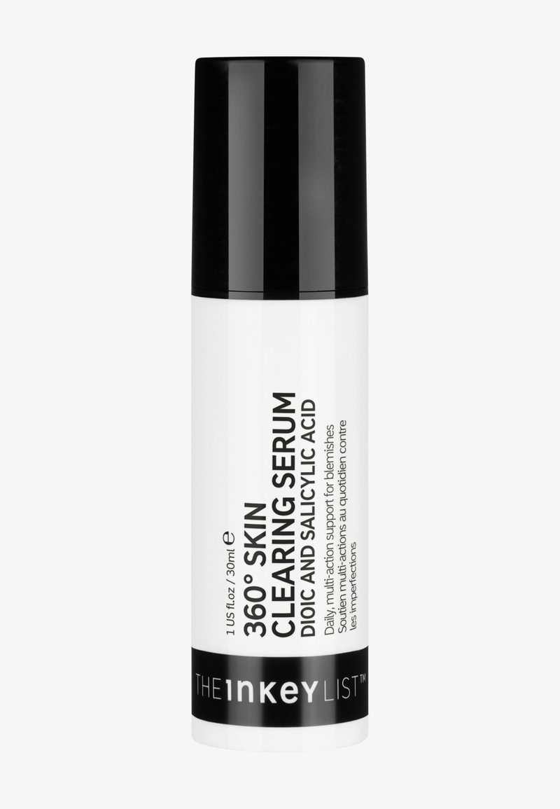 Sérum de nettoyage de peau 360° dans un flacon blanc avec un fini mat, un capuchon noir et du texte décrivant les ingrédients actifs : acide dioïque et acide salicylique.