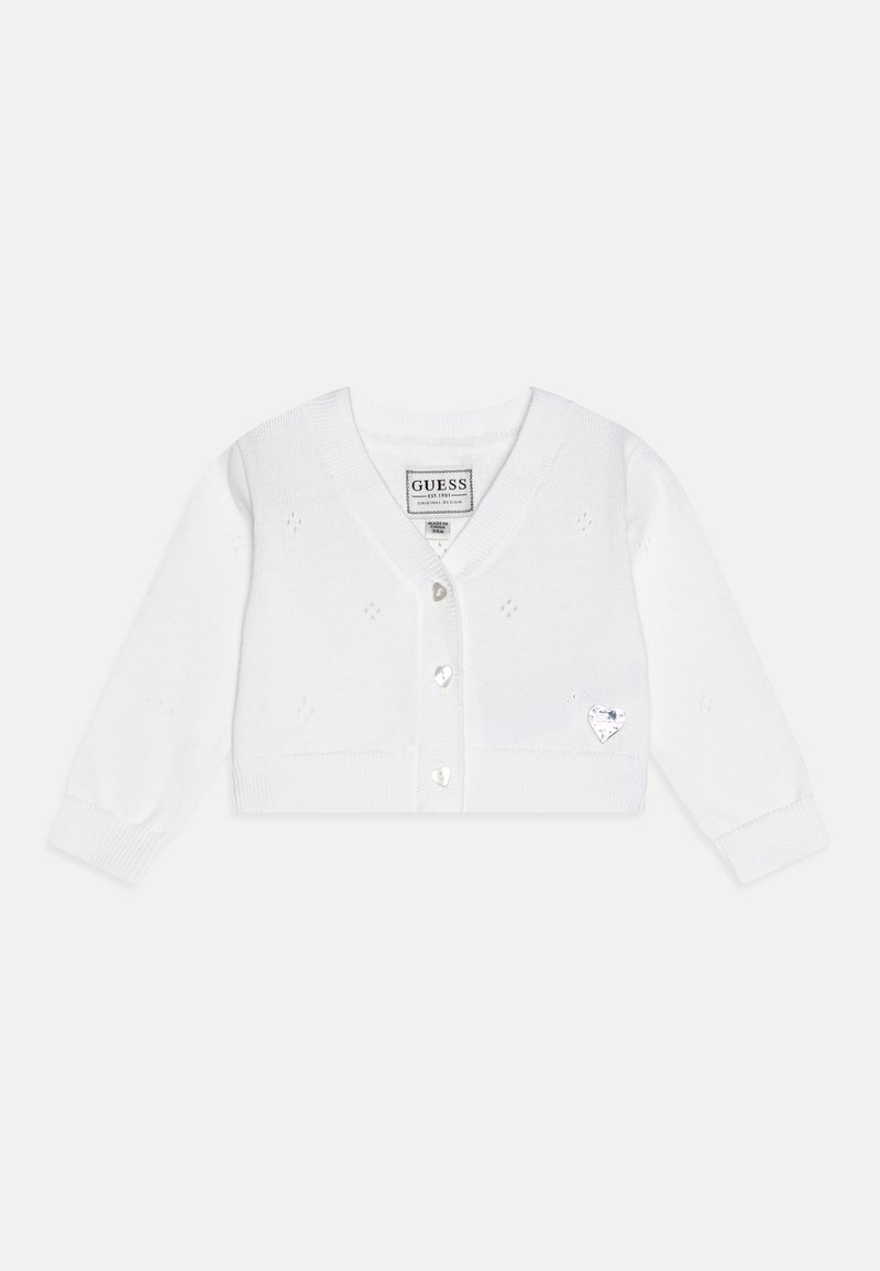Balta adīta jakas ar garām piedurknēm, V-veida kakla izgriezumu, sešām sirds formas pogām un mazu sirds logotipa aplikāciju kreisajā pusē.