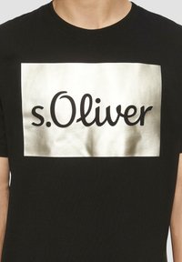 Zwarte katoenen t-shirt met een metallic zilveren rechthoekige graphic waarop de tekst "s.Oliver" in vet zwart lettertype staat. Gladde textuur.