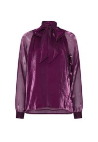 Blouse longue violette transparente à manches longues en tissu brillant, col montant et grand nœud noué au cou.