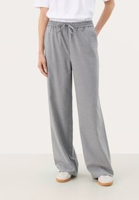 Gray, wide-leg pants with an elastic waistband and drawstring. Material appears soft with a smooth texture. Worn with light-colored shoes.