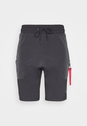 Harmaat urheilusortsit, joissa on nyörivyö, etutaskut, kontrastiväriset kankaat ja punainen vetoketjun vedin.