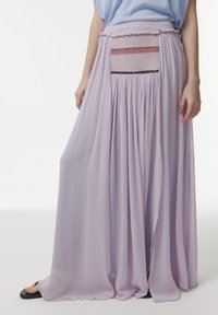 Lavender maxi rok met een geplooide tailleband, voorzien van een smockpaneel en decoratieve stiksels in roze en zwart. Lichtgewicht, vloeiende stof.