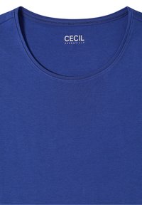 T-shirt bleu col rond avec une étiquette "CECIL ESSENTIALS" imprimée à l'intérieur du col.