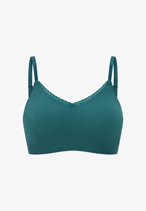 Turquoise draadloze beha met verstelbare bandjes en een getande kanten rand langs de V-hals, tegen een witte achtergrond.