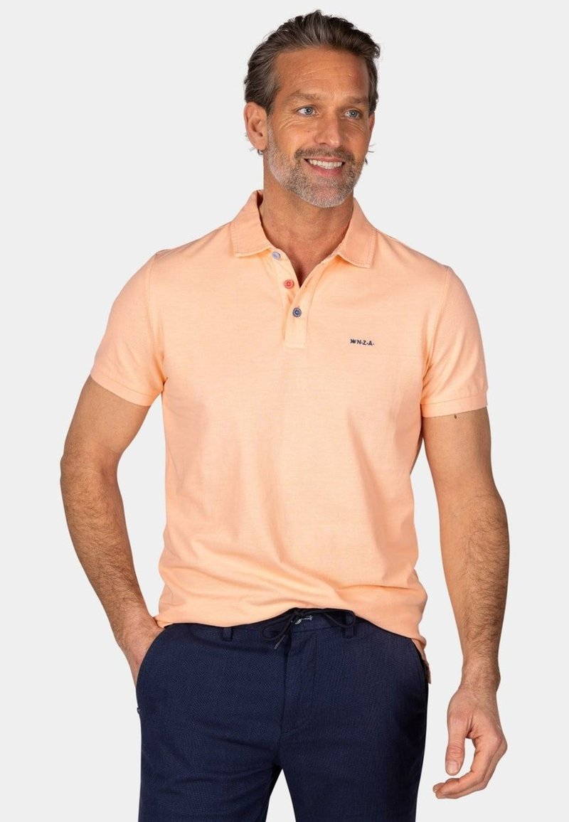 Short-sleeve polo shirt in light orange, featuring a collar and three-button placket with contrasting buttons, paired with dark navy pants.