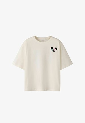 Cream-colored t-shirt with short sleeves and a round neckline, featuring a colorful heart and square graphic on the upper left chest area.