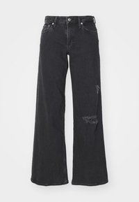 Wide-leg black denim jeans with distressed detailing on lower right leg. Features a classic button closure and five-pocket design.