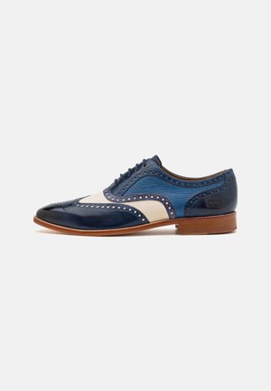 Scarpe in pelle blu e crema con dettagli brogue, punta rotonda, design stringato e tacco in legno. Gli accenti testurizzati aggiungono interesse visivo.
