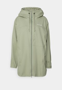 Lichtgroene Columbia softshell jas met capuchon, voorkant rits, verstelbare trekkoorden, elastische manchetten en ritszakken.