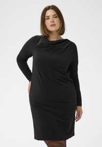 Schwarzes langärmeliges Kleid mit drapiertem Ausschnitt, aus einem strukturierten Stoff mit subtiler Schimmerung, taillierter Silhouette und knielangem Design.