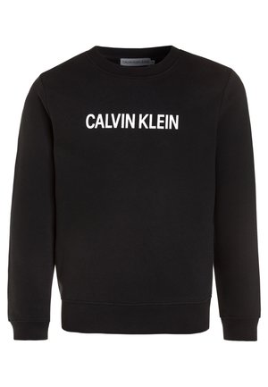 Czarna bawełniana bluza z okrągłym dekoltem, z nadrukiem "CALVIN KLEIN" dużymi białymi literami na piersi. Ściągacze na mankietach i u dołu.