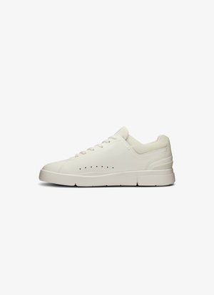 White sneaker with a smooth leather upper, textured mesh accents, perforated details, slightly elevated sole, and flat laces.