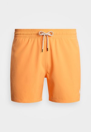Oransje svømmebukser med elastisk midje og snøring, samt en liten logo på nedre søm. Glatt stoff i ensfarget design.