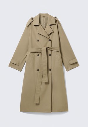 Trench-coat beige croisé avec larges revers, pattes d'épaule boutonnées, ceinture à la taille, poches latérales et poignets boutonnés.