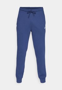 Blauwe katoenen joggers met een elastische tailleband en een trekkoord. Boorden bij de enkels. Voorzien van een klein wit logo op het bovenbeen.