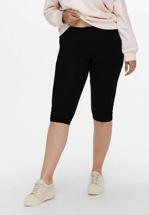 Black capri leggings made of stretchy fabric; features ankle-length fit and a wide waistband for comfort and flexibility.