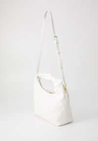 White textured leather bag with a short handle and adjustable strap, featuring a gold zipper and hardware accents. Structured shape design.