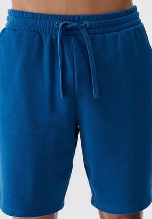 Blauwe sportbroekjes gemaakt van zachte stof, met een elastische tailleband met een trekkoord en een recht gesneden ontwerp.