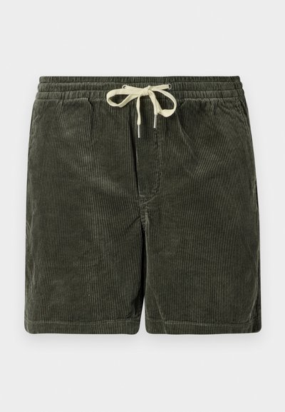 Tamsiai žali kordūrojo šortai su raišteliu. Yra vertikalios riebalų tekstūros ir metaliniai raištelio galai.