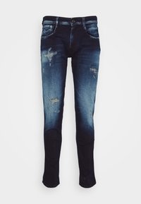 Mörkblå jeans med en blekt tvätt, som har slitna detaljer och en smal passform. Tillverkade av denim med standard femfickorsdesign.
