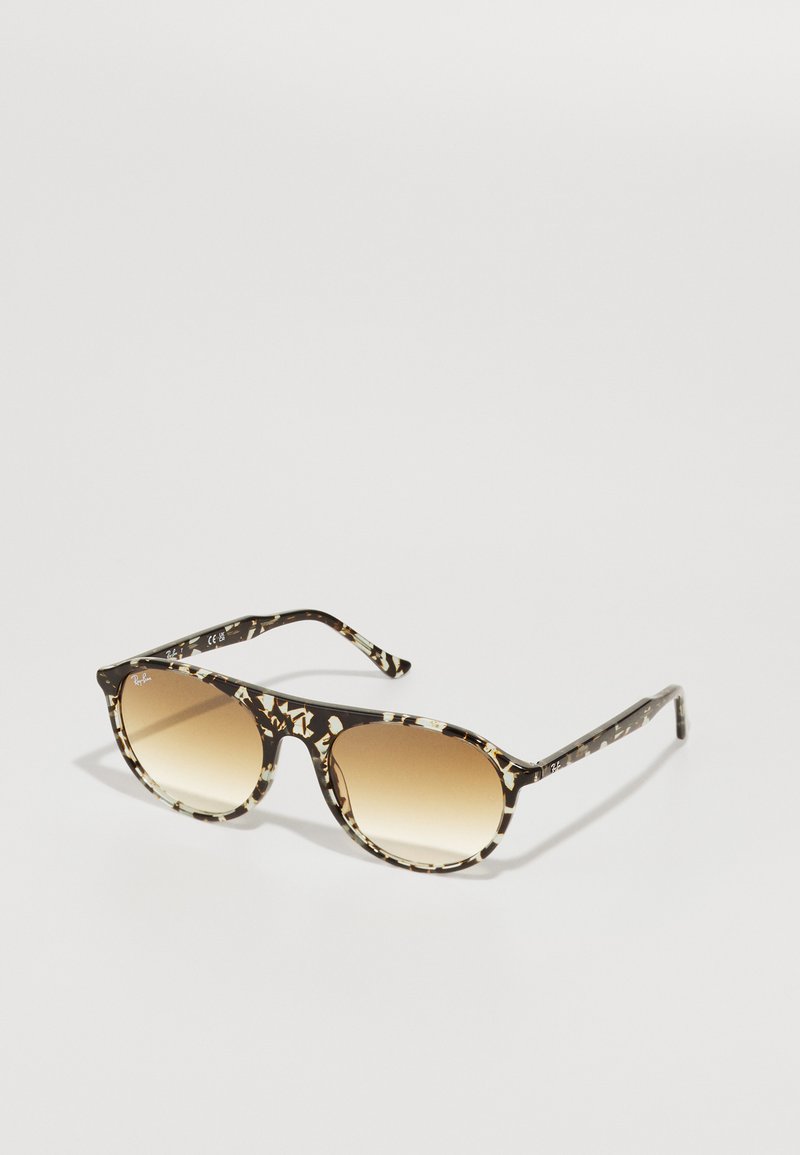 Slnečné okuliare s čierno-krémovým vzorom z acetátu, okrúhle šošovky prechádzajúce od tmavo hnedej po svetlo hnedú a štíhle rámiky.