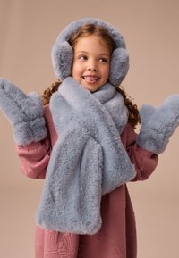 Light blue faux fur earmuffs, scarf, and mittens, with a soft texture and rounded shapes, paired with a pink patterned sweater.