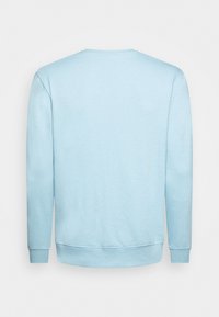Sudadera azul claro de manga larga, con cuello redondo, puños y dobladillo acanalados. Textura de tela suave, diseño minimalista, sin logotipos visibles.