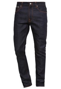 Mörkblå denimjeans med en figursydd design, orange sömmar, en klassisk femfickslayout och knappgylf.