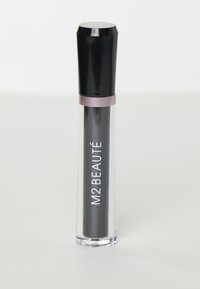 Tuyau transparent avec un capuchon noir, contenant un produit sombre. L'étiquette "M2 BEAUTÉ" est imprimée en blanc sur le côté. Design épuré.