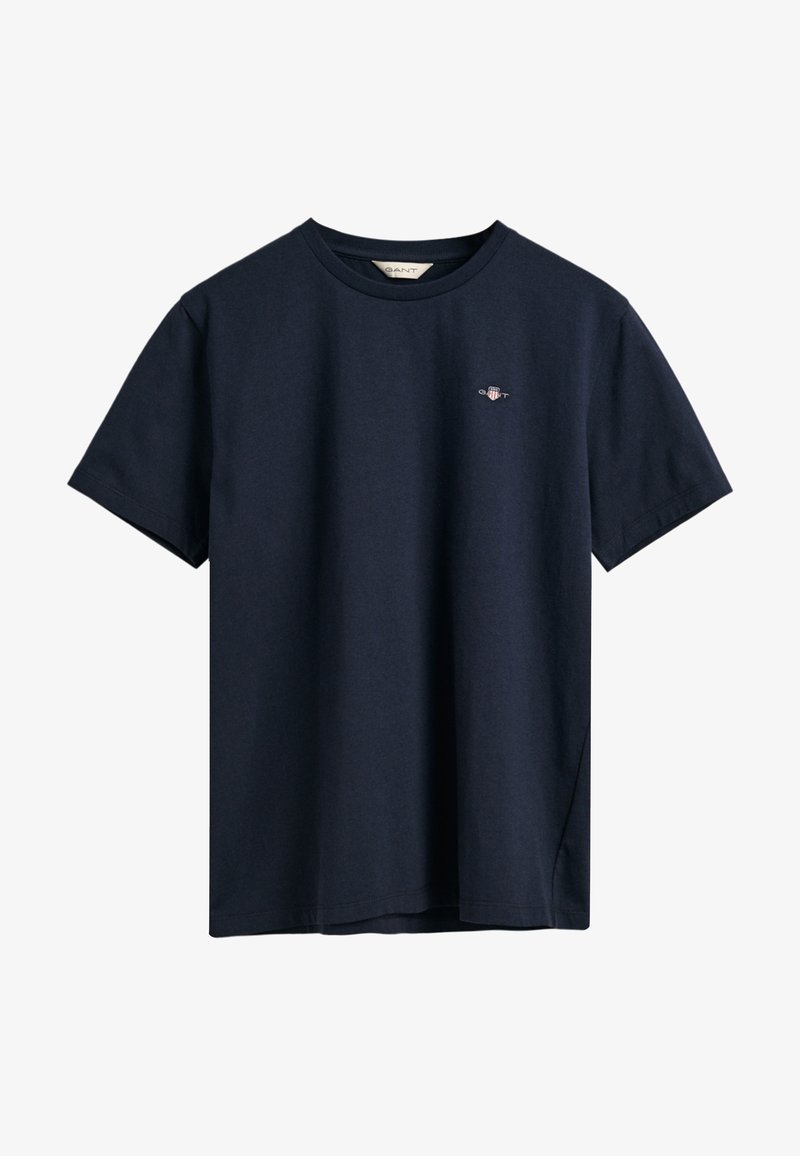 Námorně modré bavlněné tričko s krátkým rukávem, kulatým výstřihem a malým logem na hrudi. Měkká textura s volným střihem.