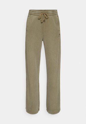 Olivengrønne joggebukser med snøring i midjen, sidelommer og løs passform. Laget av mykt materiale, med enkel design og søm.